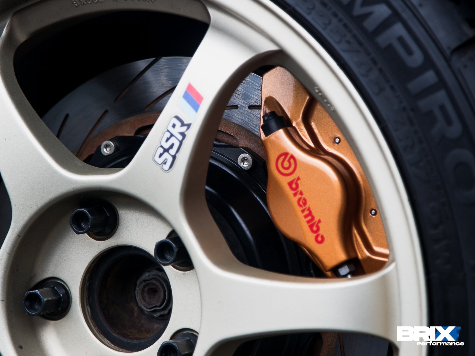 Close-up of BMW E36, showing rear wheel fitment and camber setup.