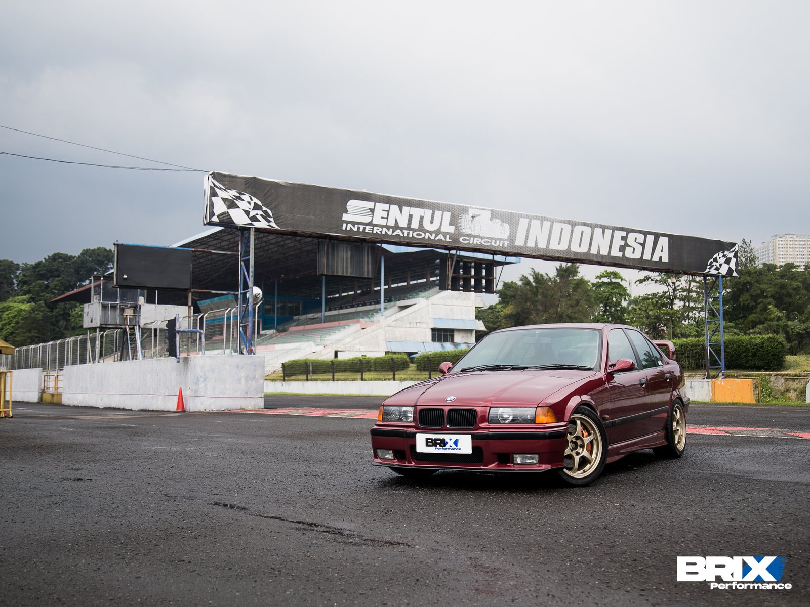 BMW E36 parked at Sonder Studio, displaying full car and lowered setup.