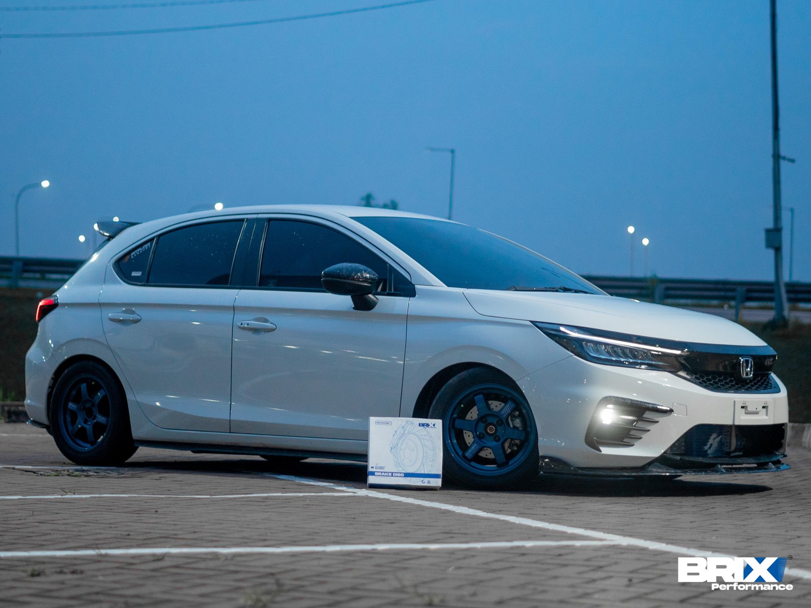Honda City Hatchback equipped with BRIX Performance Street Series brake rotors, parked at dusk.