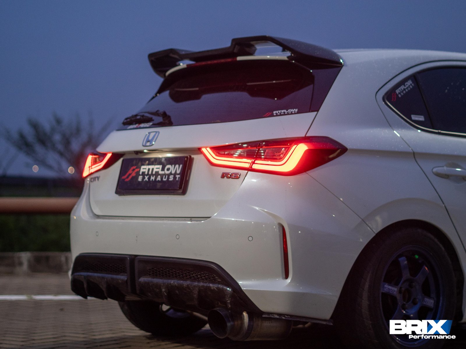 Rear shot of modified Honda City Hatchback RS with upgraded braking system and aftermarket exhaust.